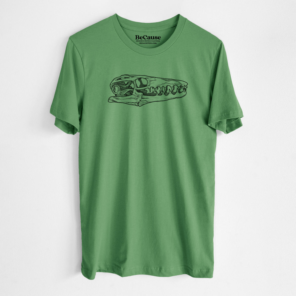 Leaf green lightweight cotton t-shirt laid flat, printed with a detailed black ink illustration of a Mosasaur skull.