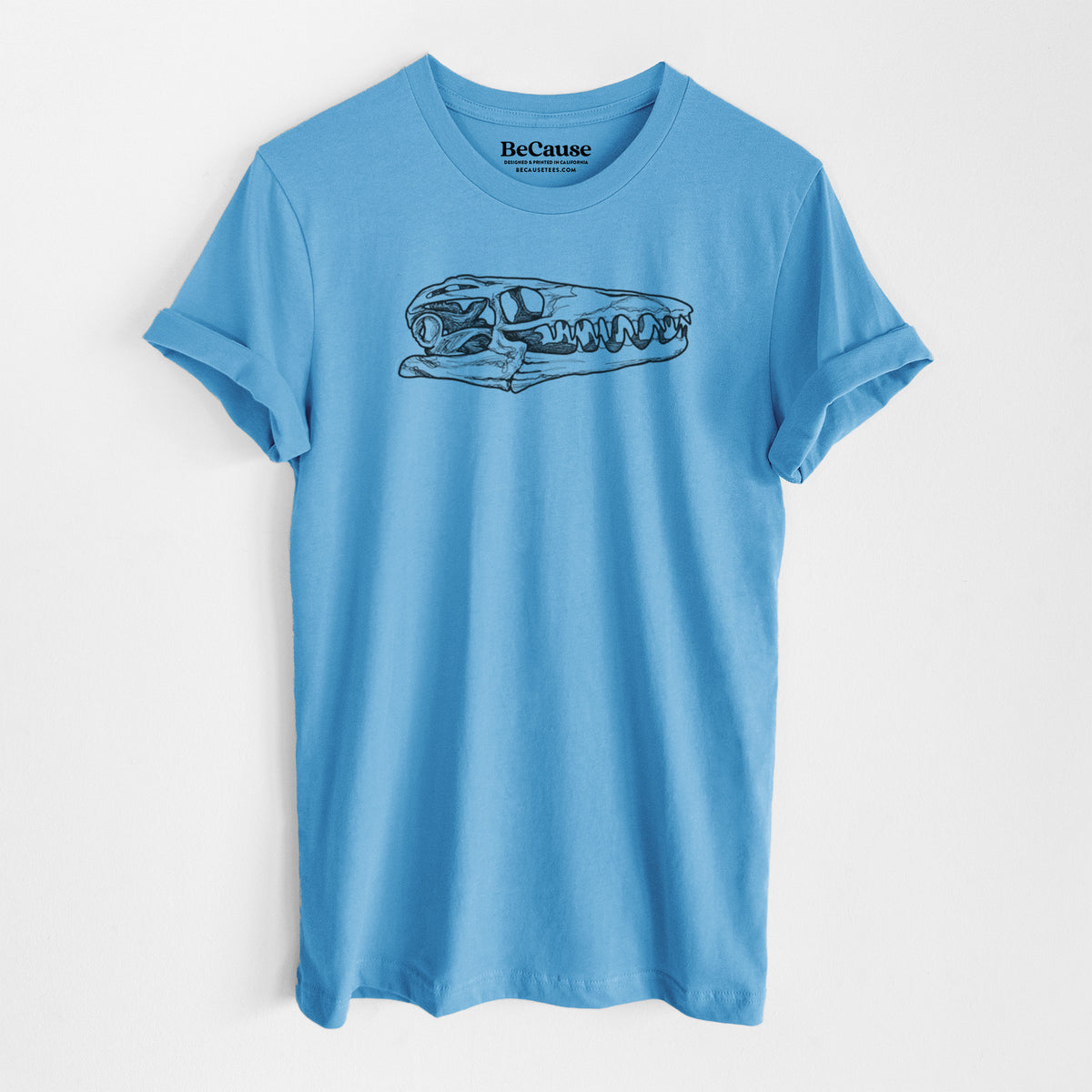 Ocean blue lightweight cotton t-shirt laid flat, printed with a detailed black ink illustration of a Mosasaur skull.