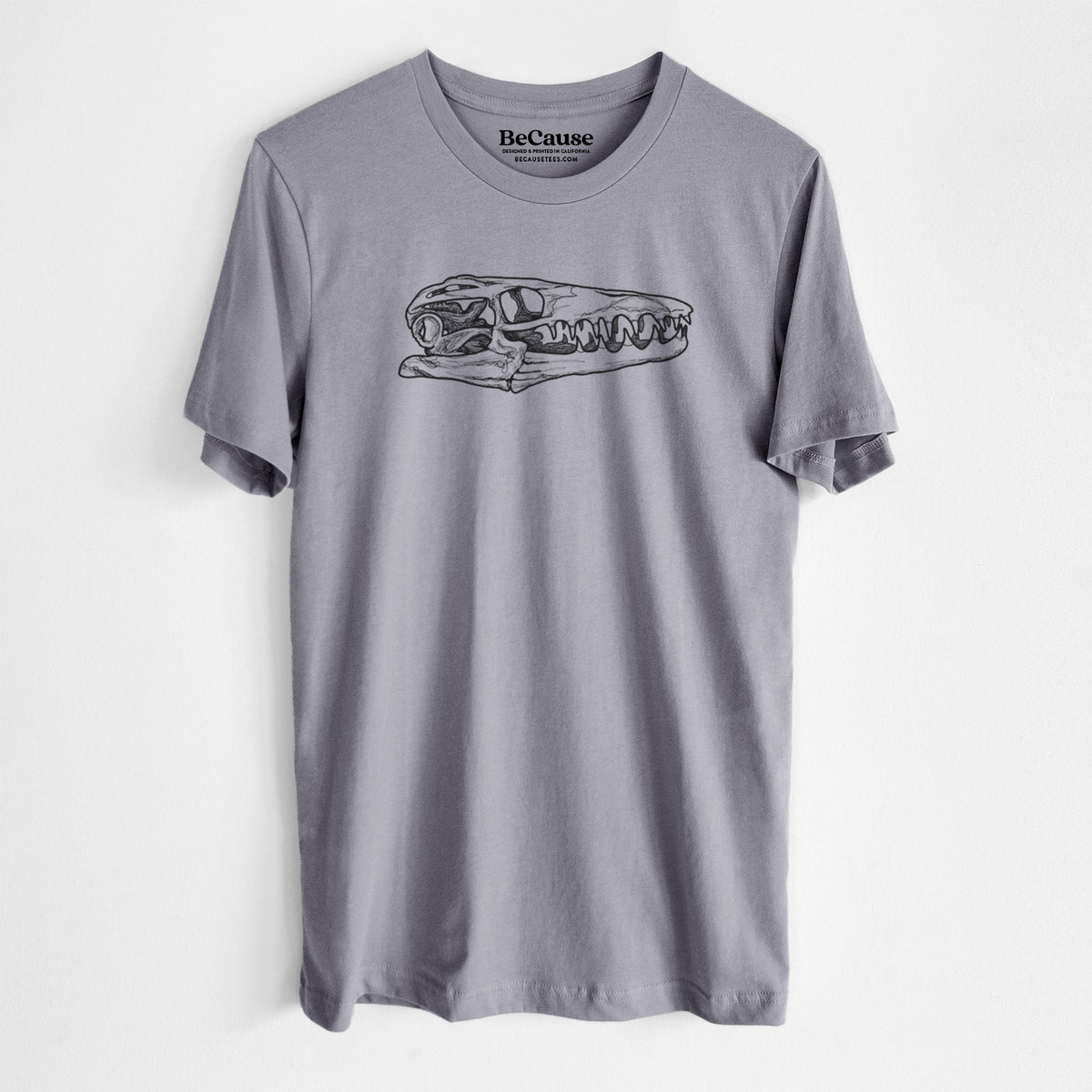 Storm grey lightweight cotton t-shirt laid flat, printed with a detailed black ink illustration of a Mosasaur skull.