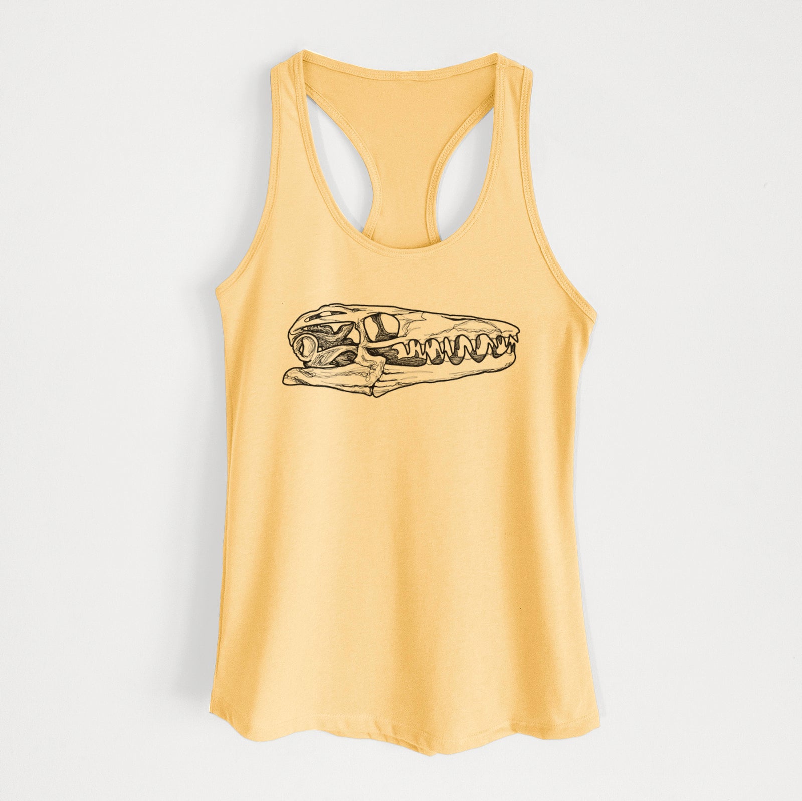 Banana cream women's racerback tank top laid flat, printed with a detailed black ink illustration of a Mosasaur skull.
