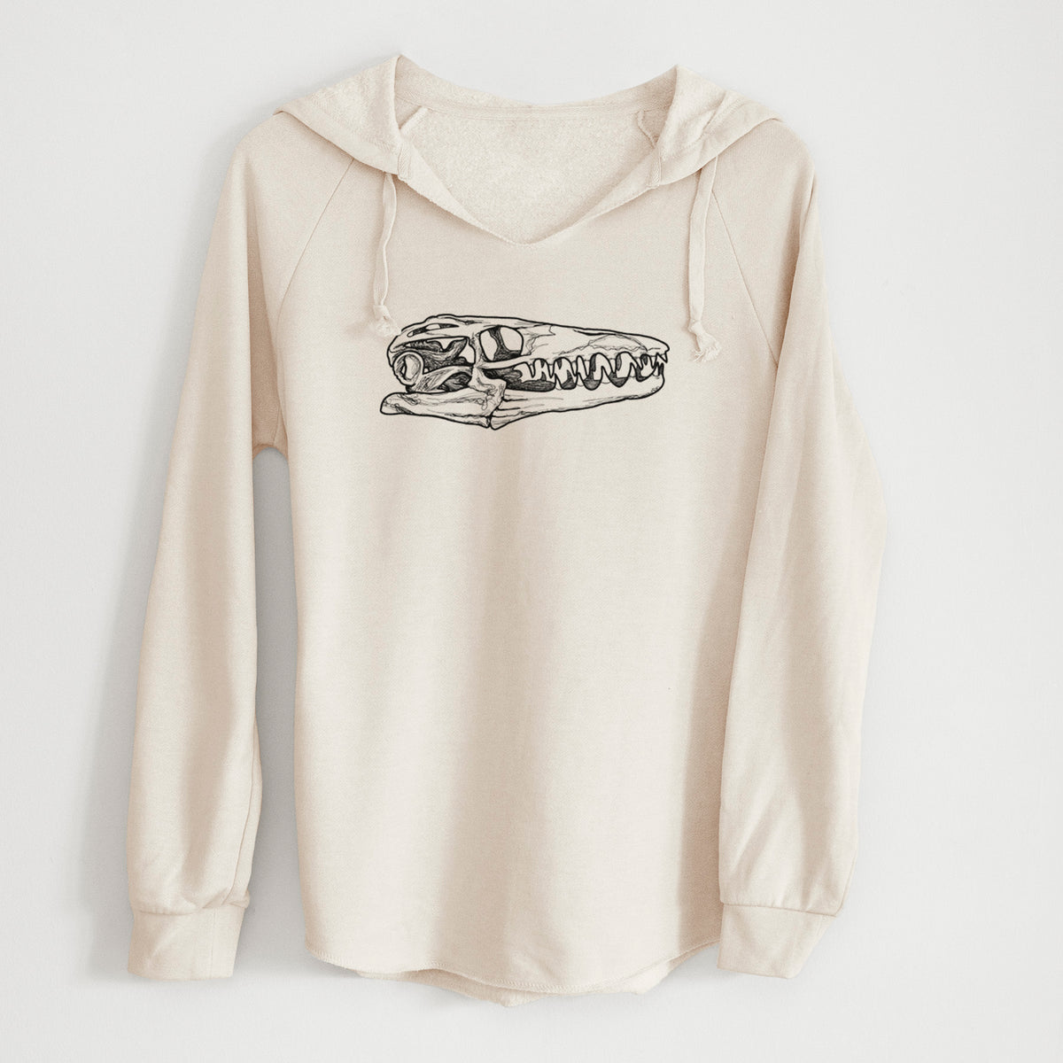 Bone cream women's Cali Wave hooded sweatshirt laid flat, printed with a detailed black ink illustration of a Mosasaur skull.