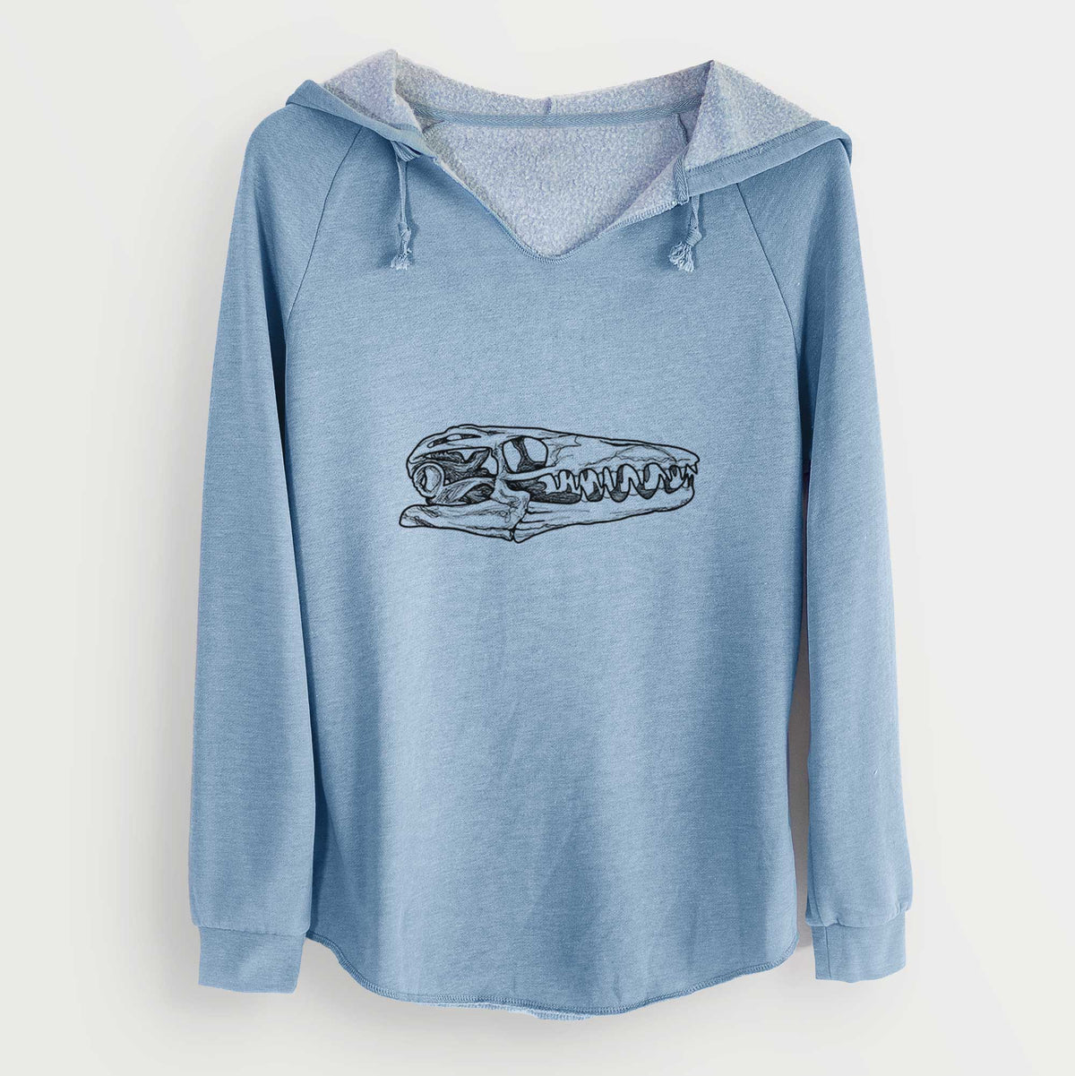 Misty blue women's Cali Wave hooded sweatshirt laid flat, printed with a detailed black ink illustration of a Mosasaur skull.