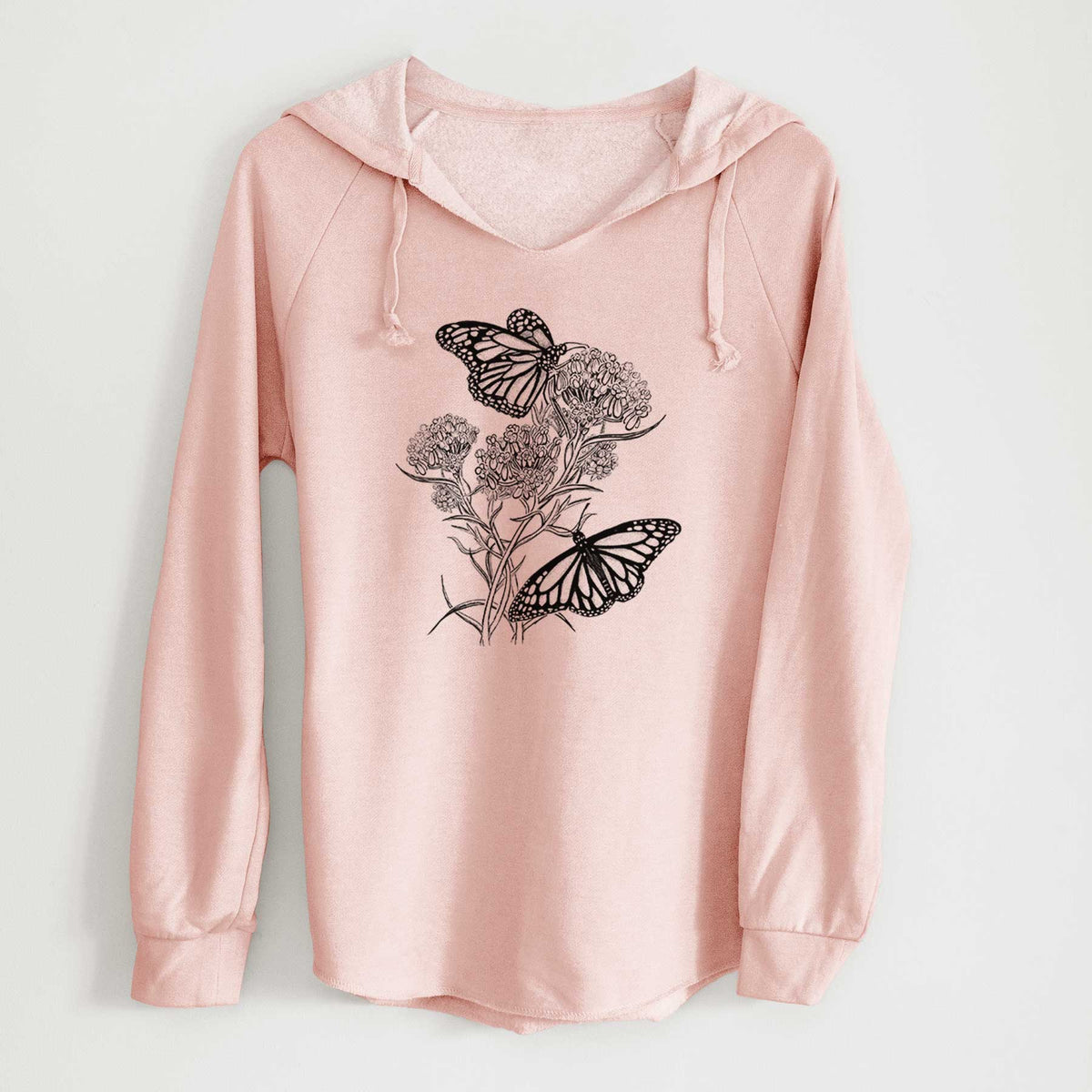 Blush pink women's Cali Wave hooded sweatshirt laid flat, printed with a black ink illustration of two monarch butterflies on flowering milkweed.