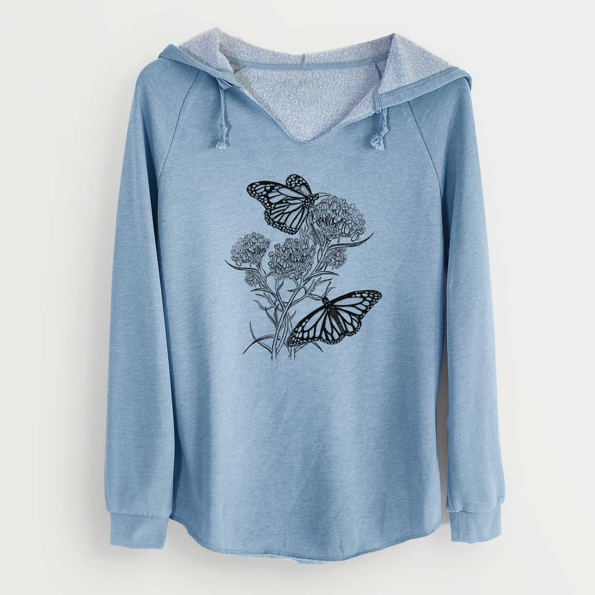 Misty blue women's Cali Wave hooded sweatshirt laid flat, printed with a black ink illustration of two monarch butterflies on flowering milkweed.