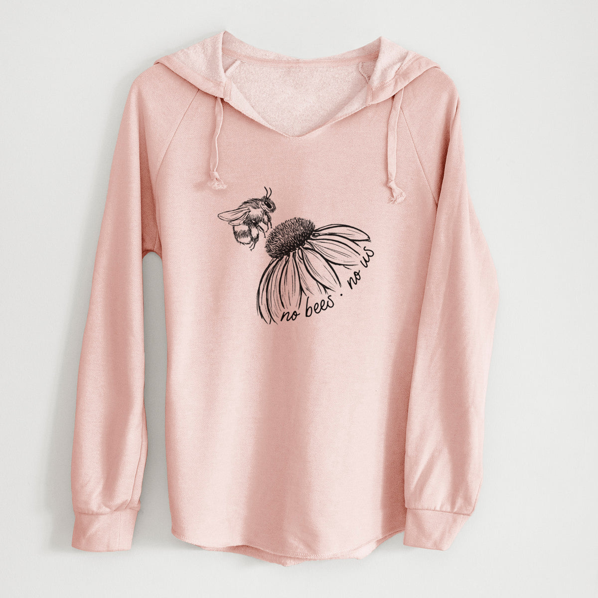 Blush pink women's Cali Wave hooded sweatshirt laid flat, printed with a black ink illustration of a bee flying toward a coneflower, with the handwritten words no bees no us.