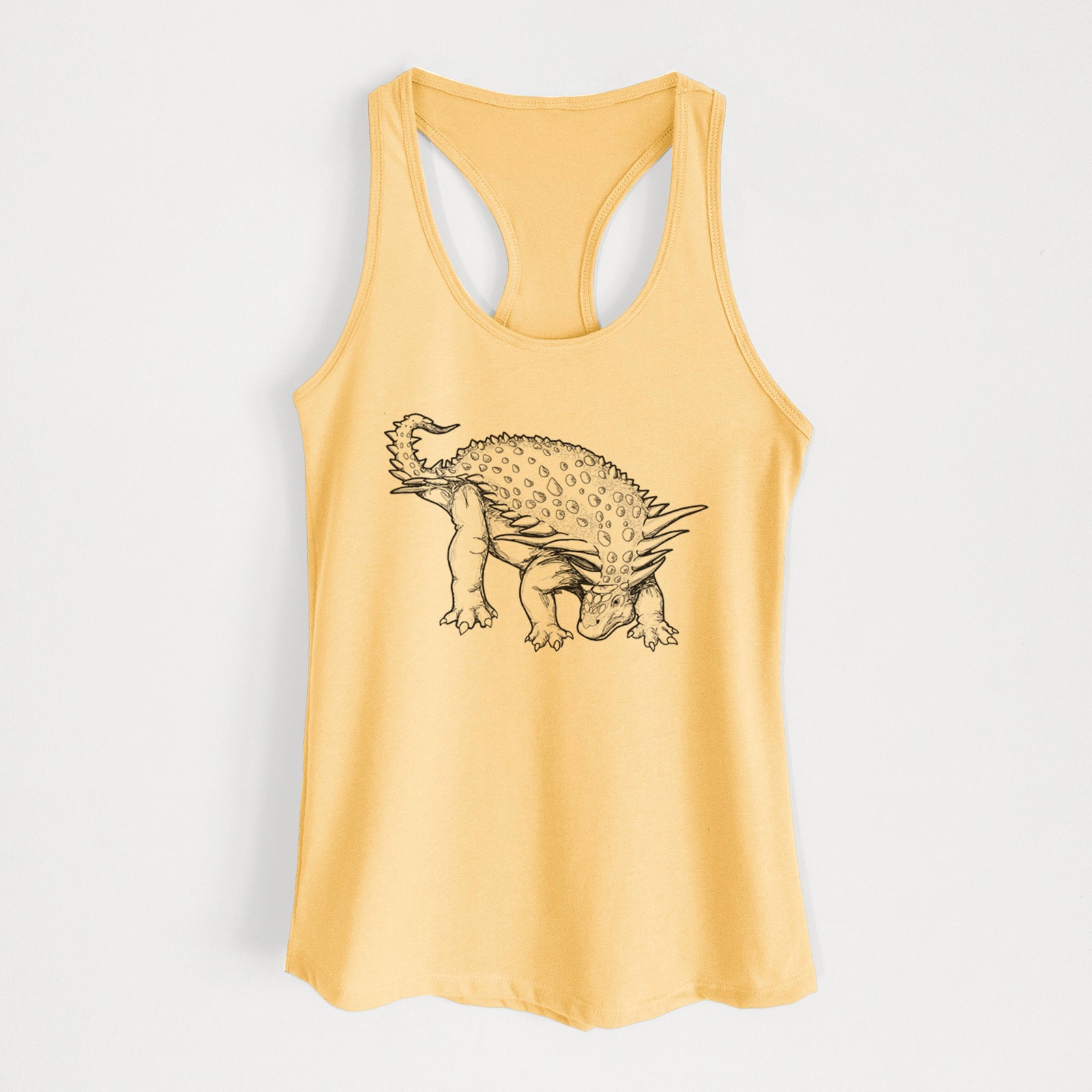 Banana cream women's racerback tank top laid flat, printed with a black ink illustration of an armored Nodosaurus.