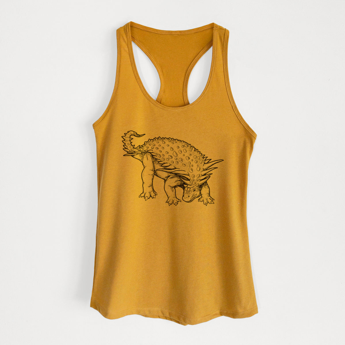Gold women's racerback tank top laid flat, printed with a black ink illustration of an armored Nodosaurus.