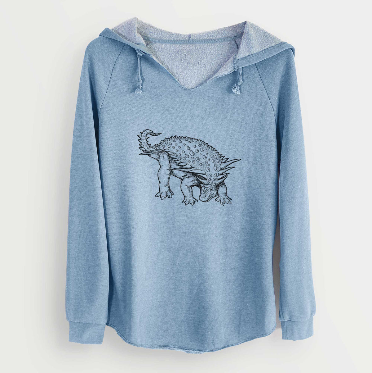 Misty blue women's Cali Wave hooded sweatshirt laid flat, printed with a black ink illustration of an armored Nodosaurus.