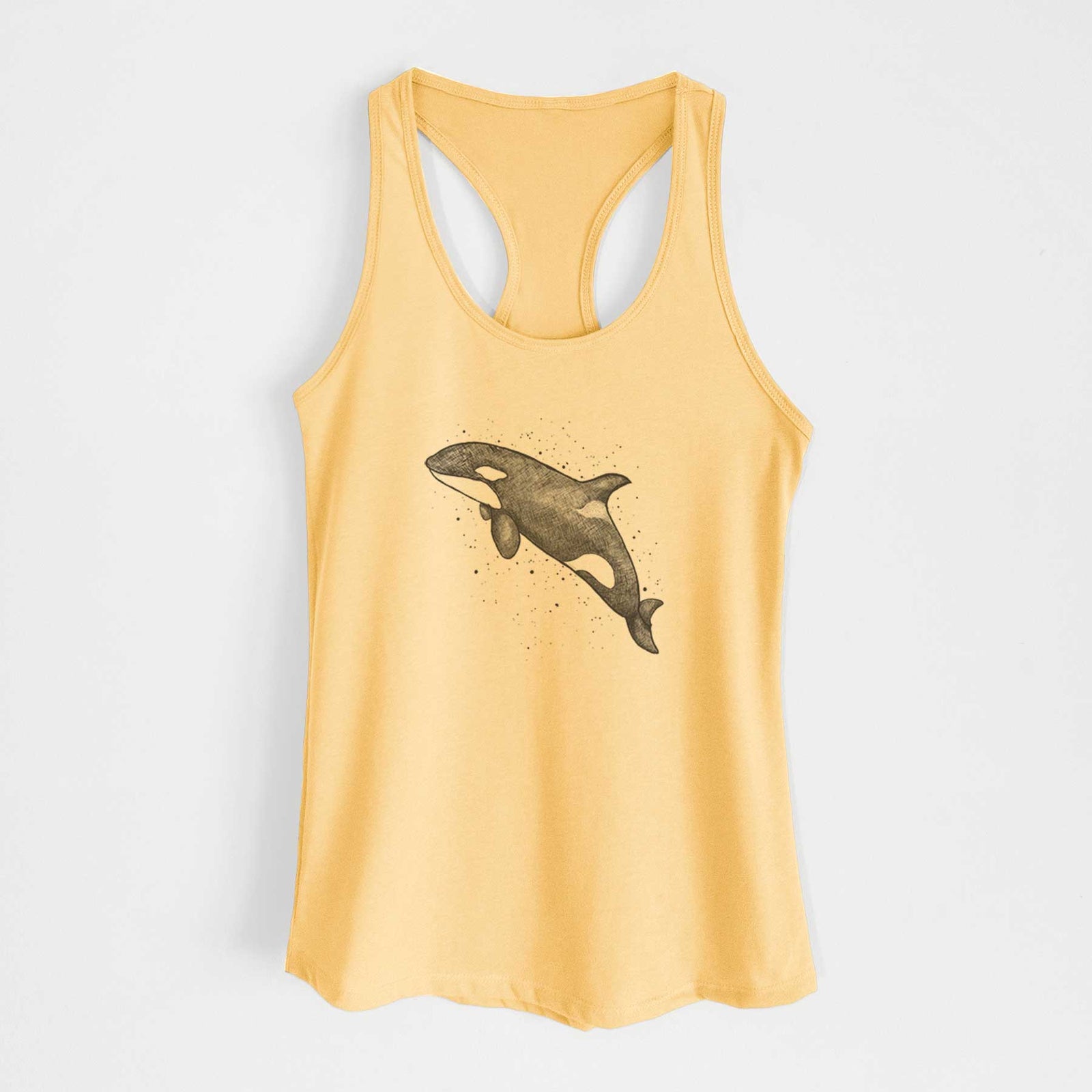 Banana cream women's racerback tank top laid flat, printed with a black ink illustration of an orca leaping, with ink splatters.