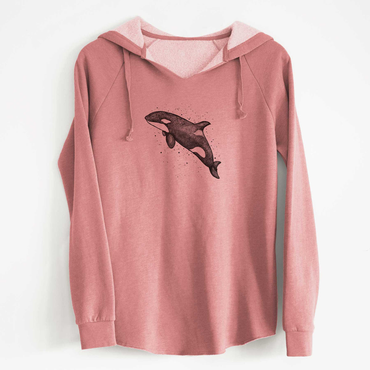 Dusty rose women's Cali Wave hooded sweatshirt laid flat, printed with a black ink illustration of an orca leaping, with ink splatters.