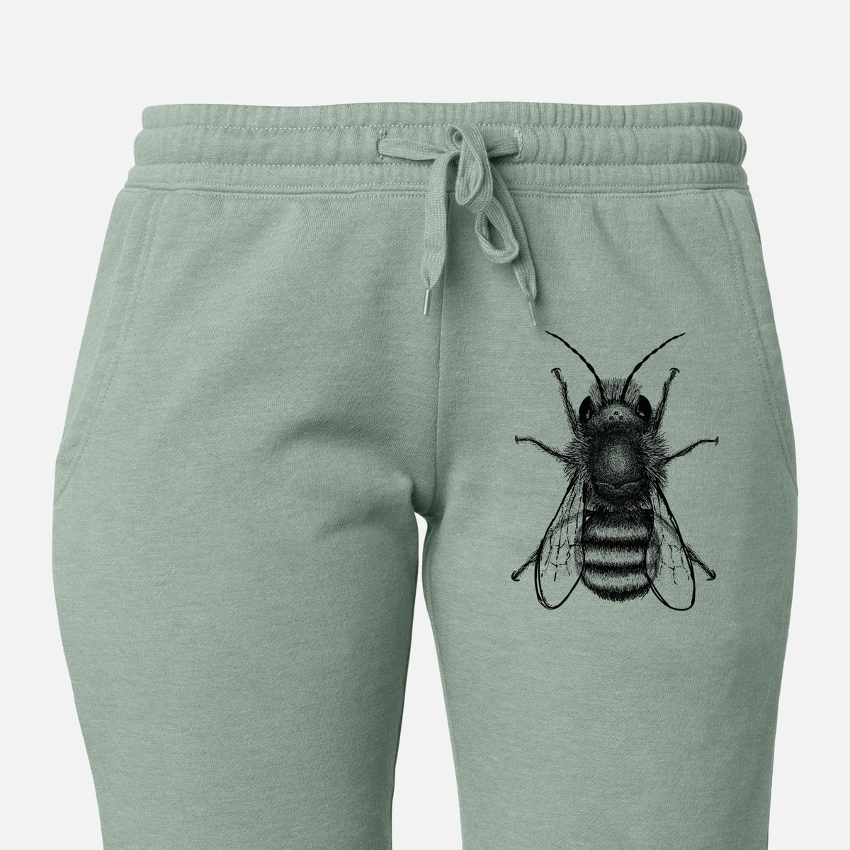 Front of sage green Cali Wave sweatpants, printed with a detailed black ink illustration of a red mason bee with its wings spread, seen from above on the leg.