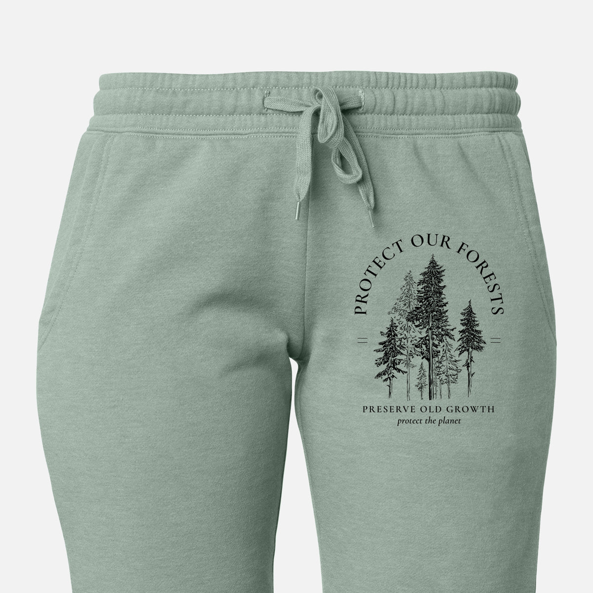Front of sage green Cali Wave sweatpants, printed with a black ink illustration of a stand of tall pine trees, framed by the words Protect Our Forests, Preserve Old Growth on the leg.