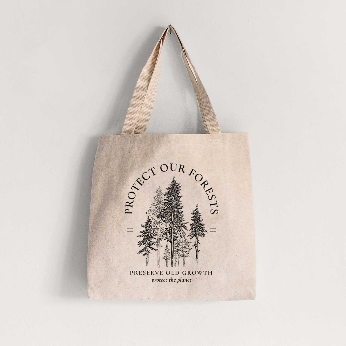 Natural canvas tote bag printed with a black ink illustration of a stand of tall pine trees, framed by the words Protect Our Forests, Preserve Old Growth.