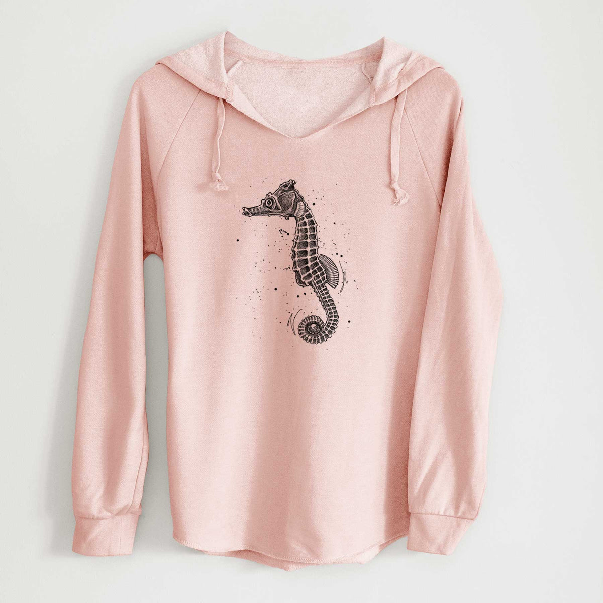 Blush pink women's Cali Wave hooded sweatshirt laid flat, printed with a detailed black ink illustration of a Pacific seahorse with its tail curled.