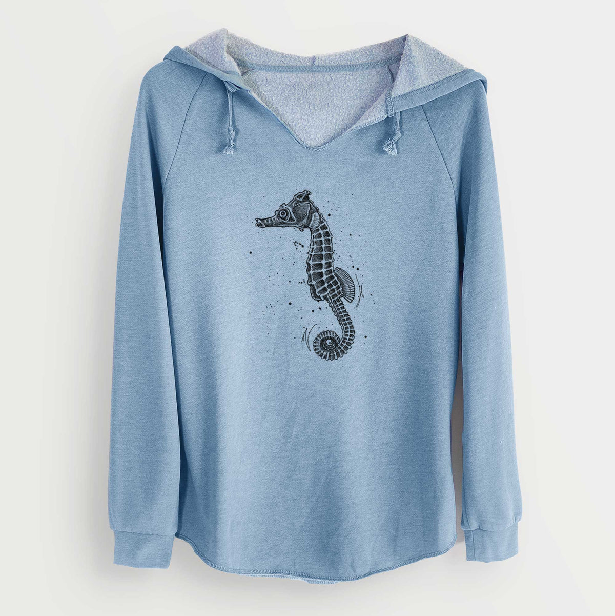 Misty blue women's Cali Wave hooded sweatshirt laid flat, printed with a detailed black ink illustration of a Pacific seahorse with its tail curled.