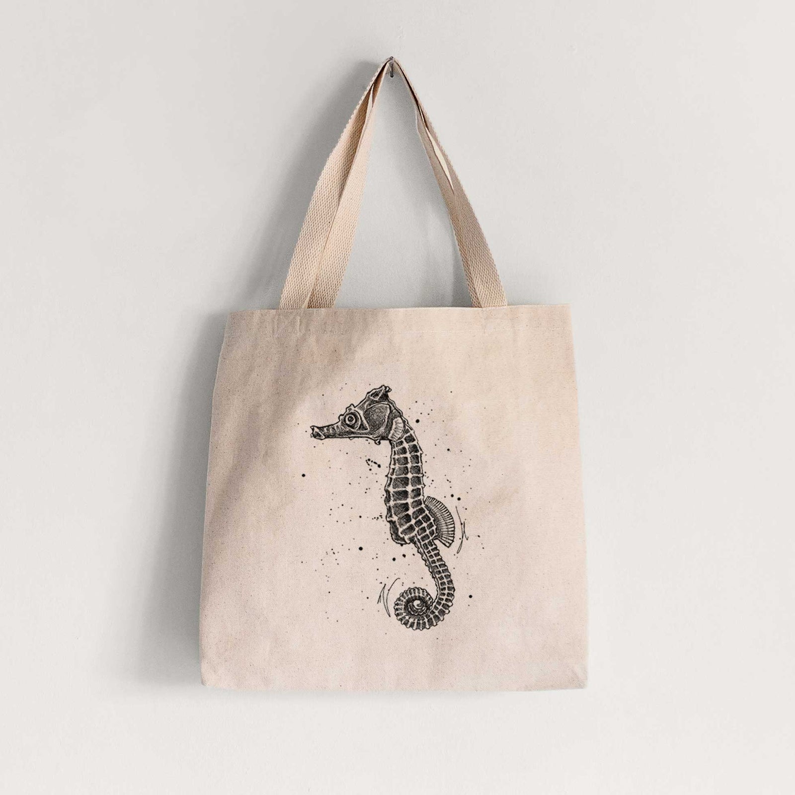 Natural canvas tote bag printed with a detailed black ink illustration of a Pacific seahorse with its tail curled.