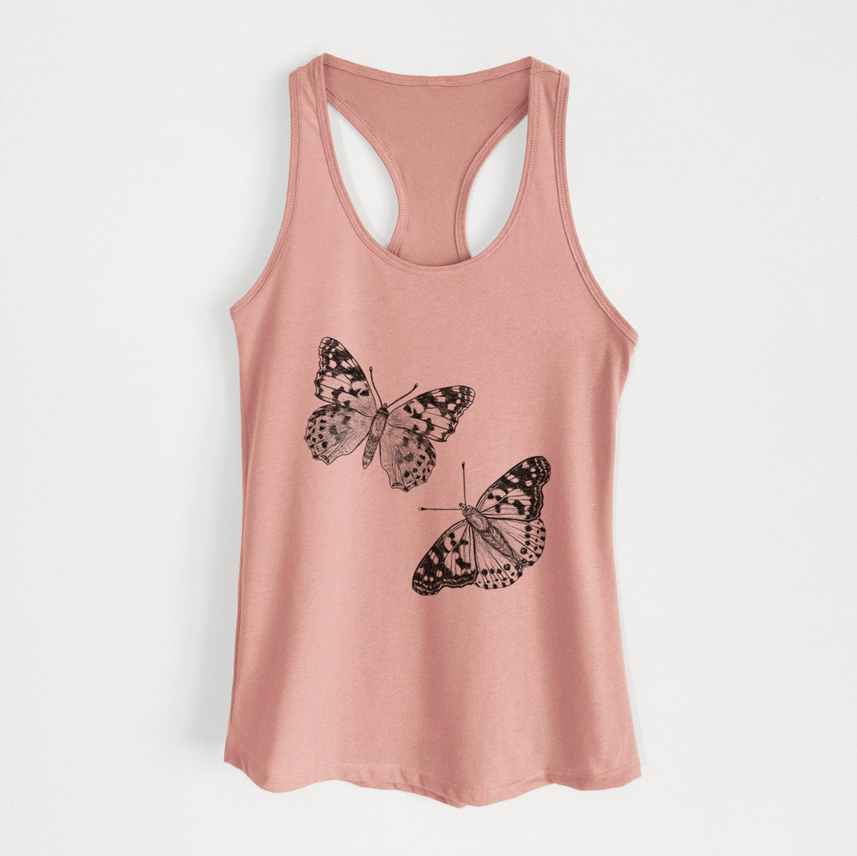 Desert pink women's racerback tank top laid flat, printed with a detailed black ink illustration of two painted lady butterflies.