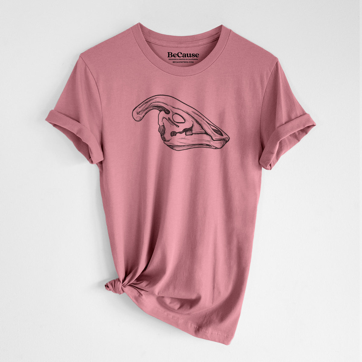 Mauve pink lightweight cotton t-shirt laid flat with the sleeves rolled, printed with a detailed black ink illustration of a crested Parasaurolophus skull.