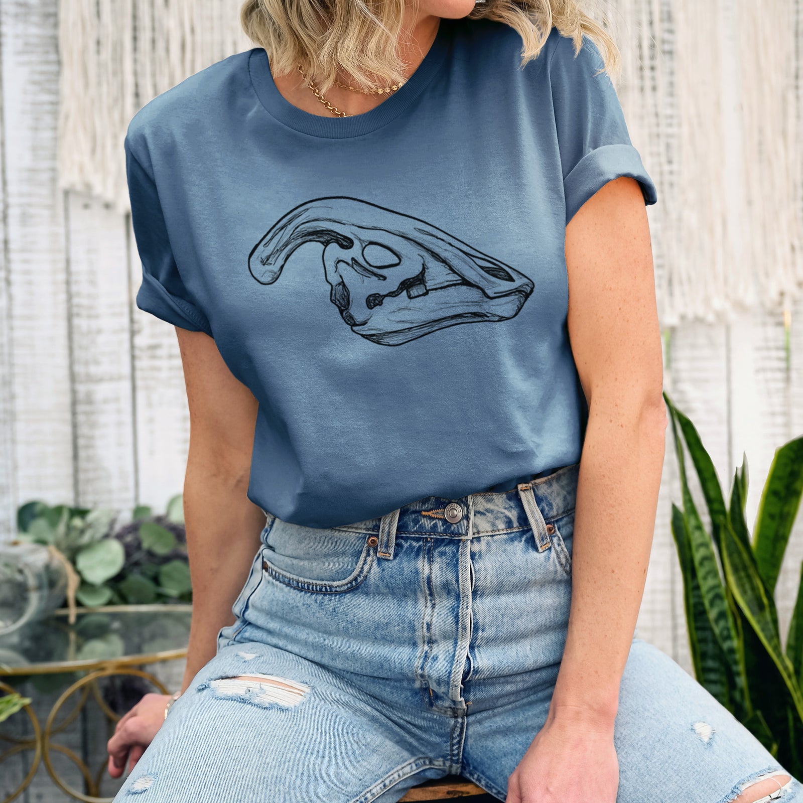 Autumn lightweight cotton t-shirt laid flat, printed with a detailed black ink illustration of a crested Parasaurolophus skull.