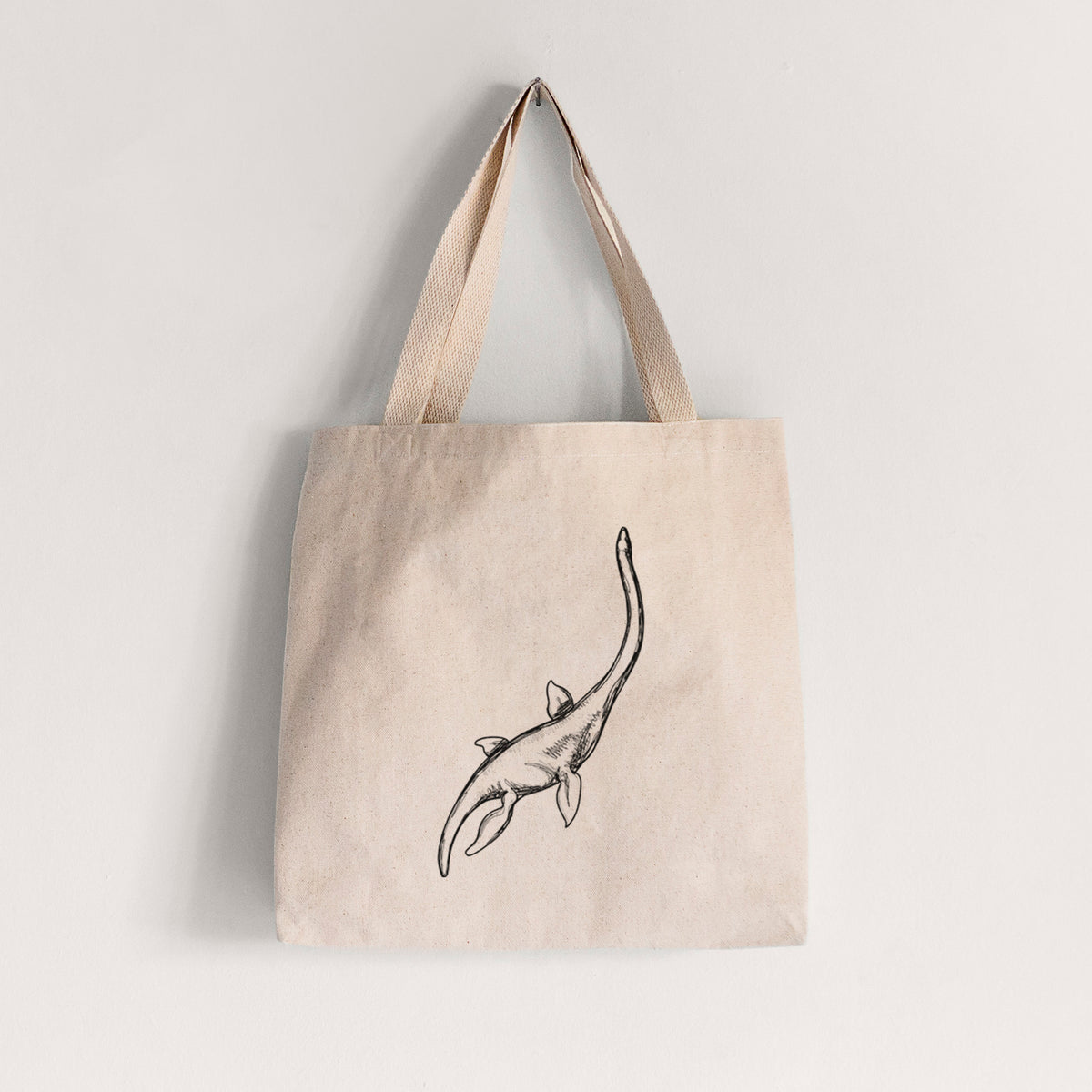 Natural canvas tote bag printed with a black ink illustration of a long-necked plesiosaur swimming.