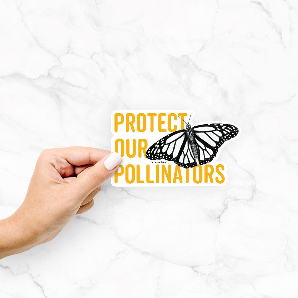 Hand holding a vinyl decal of yellow words reading Protect Our Pollinators beside a black ink monarch butterfly.