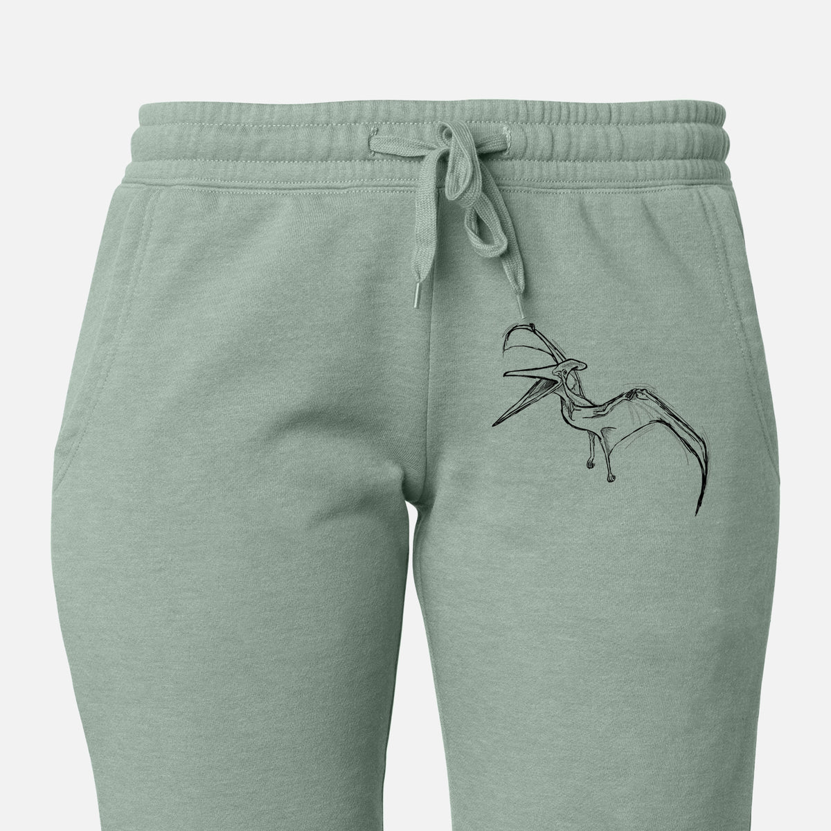 Front of sage green Cali Wave sweatpants, printed with a black ink illustration of a Pteranodon in flight on the leg.