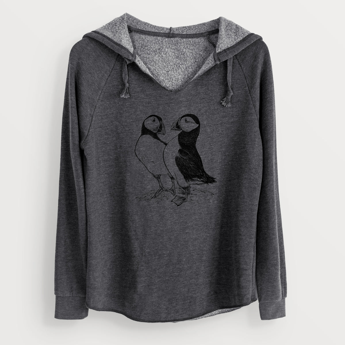 Charcoal grey women's Cali Wave hooded sweatshirt laid flat, printed with a detailed black ink illustration of two Atlantic puffins standing side by side.