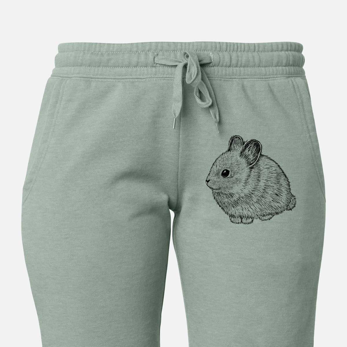 Front of sage green Cali Wave sweatpants, printed with a detailed black ink illustration of a round, fluffy pygmy rabbit on the leg.