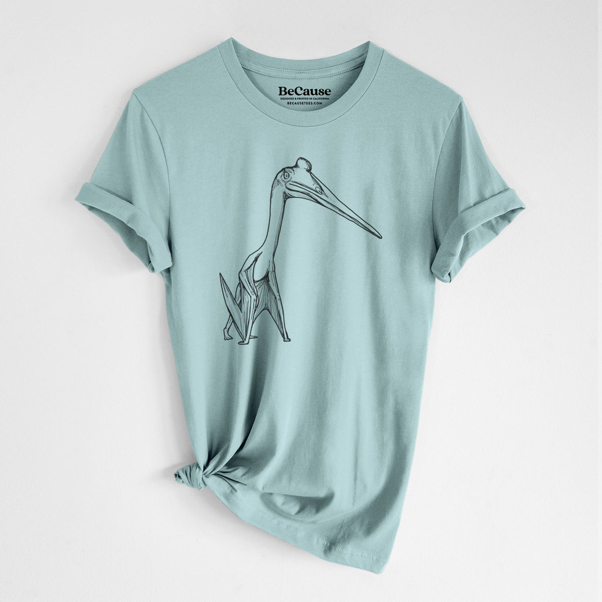 Dusty blue lightweight cotton t-shirt laid flat with the sleeves rolled, printed with a black ink illustration of a Quetzalcoatlus pterosaur standing on all fours.
