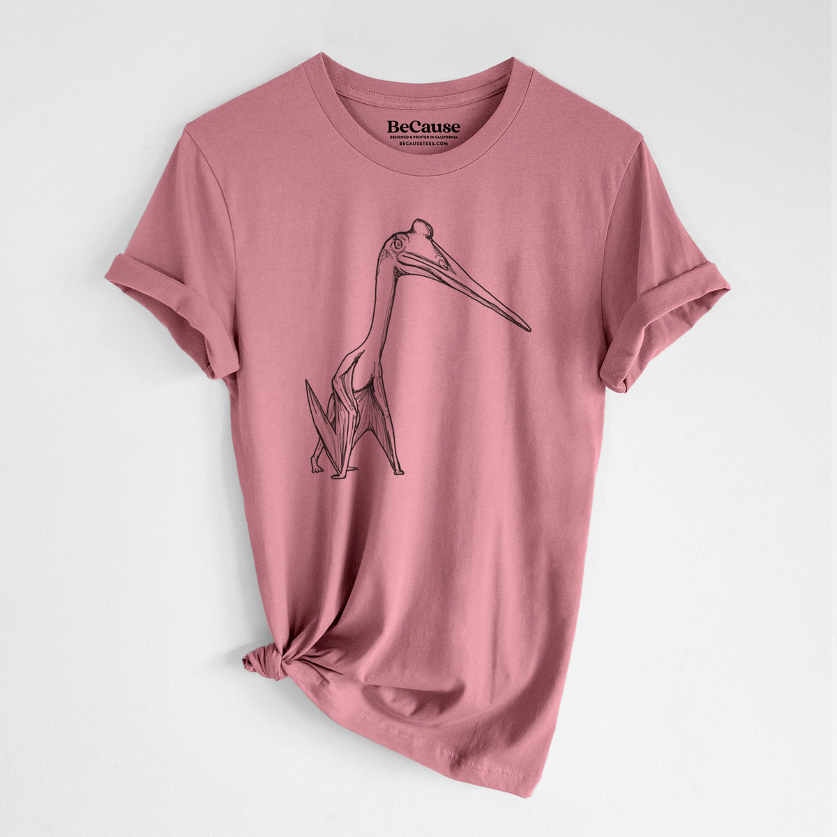Mauve pink lightweight cotton t-shirt laid flat with the sleeves rolled, printed with a black ink illustration of a Quetzalcoatlus pterosaur standing on all fours.