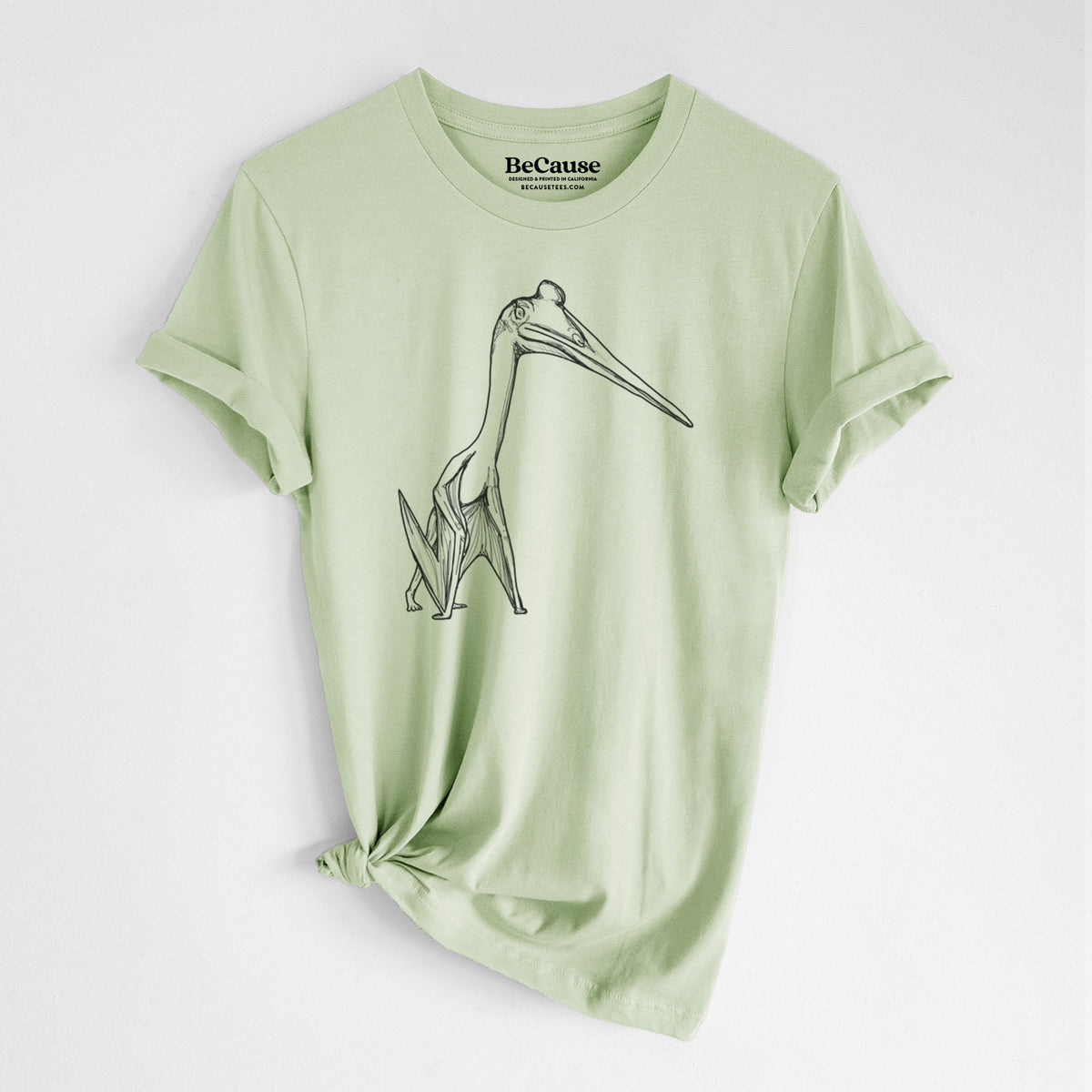 Spring green lightweight cotton t-shirt laid flat with the sleeves rolled, printed with a black ink illustration of a Quetzalcoatlus pterosaur standing on all fours.