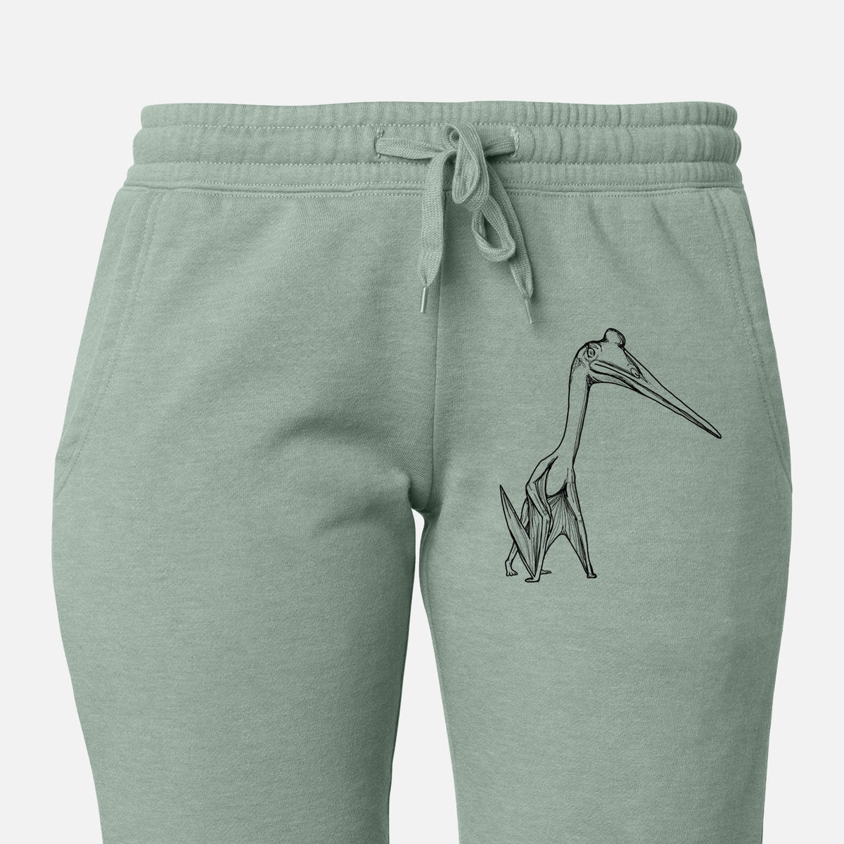 Front of sage green Cali Wave sweatpants, printed with a black ink illustration of a Quetzalcoatlus pterosaur standing on all fours on the leg.