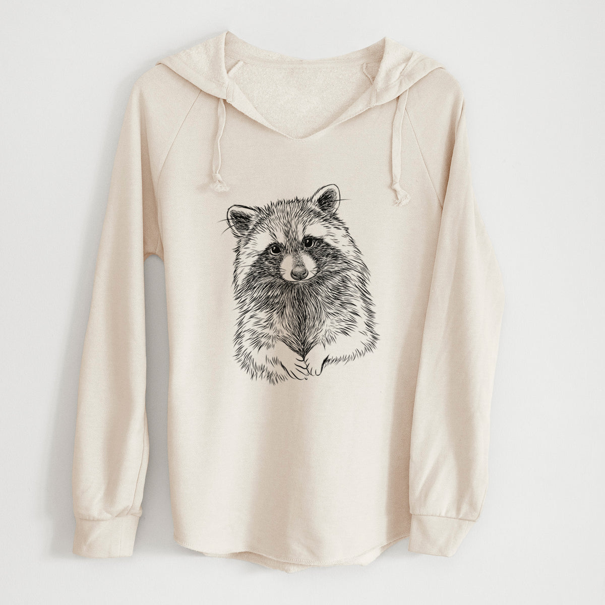 Bone cream women's Cali Wave hooded sweatshirt laid flat, printed with a detailed black ink portrait of a raccoon with its front paws resting in front of it.