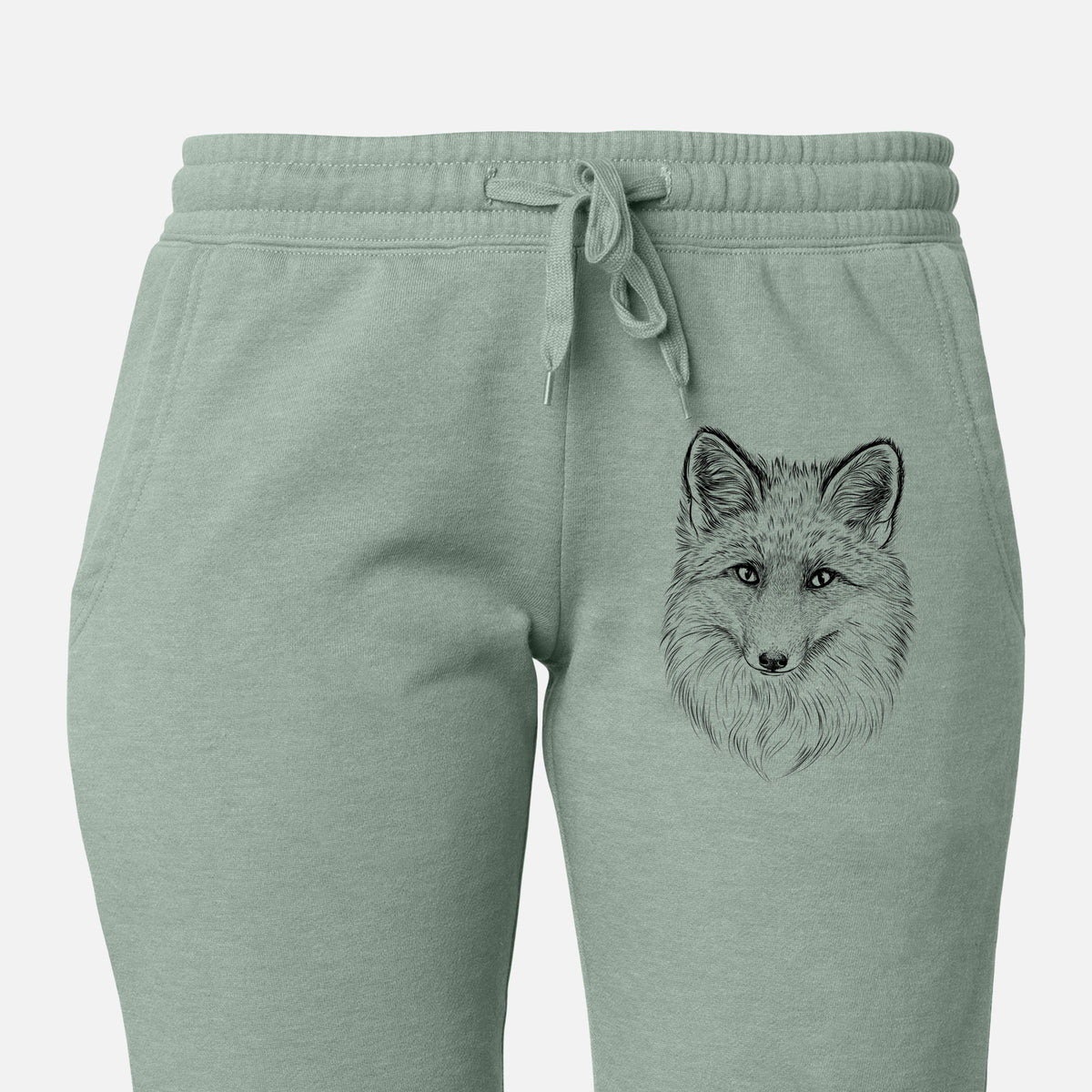 Front of sage green Cali Wave sweatpants, printed with a detailed black ink sketch of a red fox's face looking straight ahead, its fur drawn in fine pencil-like strokes on the leg.