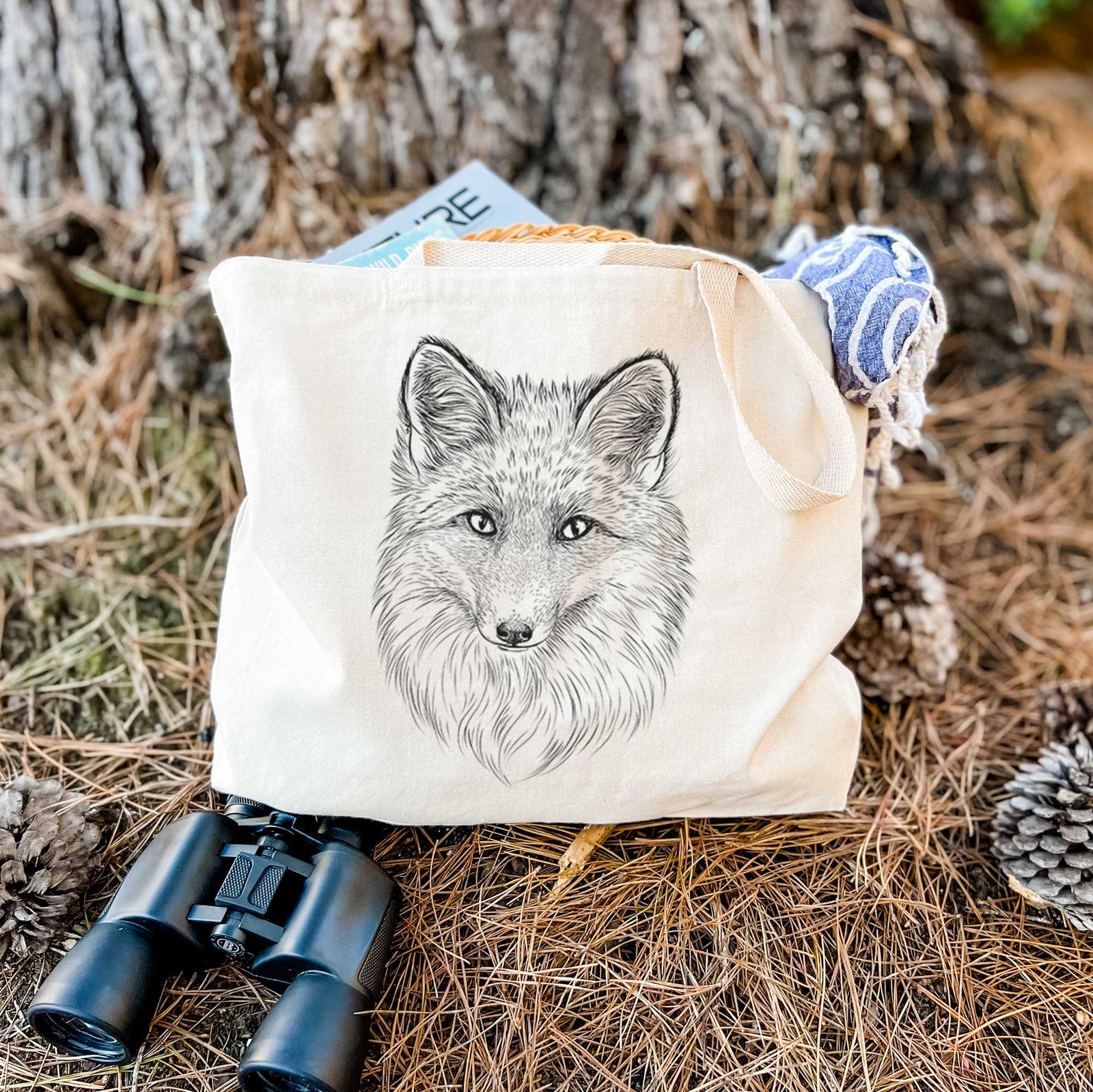 Natural canvas tote bag printed with a detailed black ink sketch of a red fox's face looking straight ahead, its fur drawn in fine pencil-like strokes.