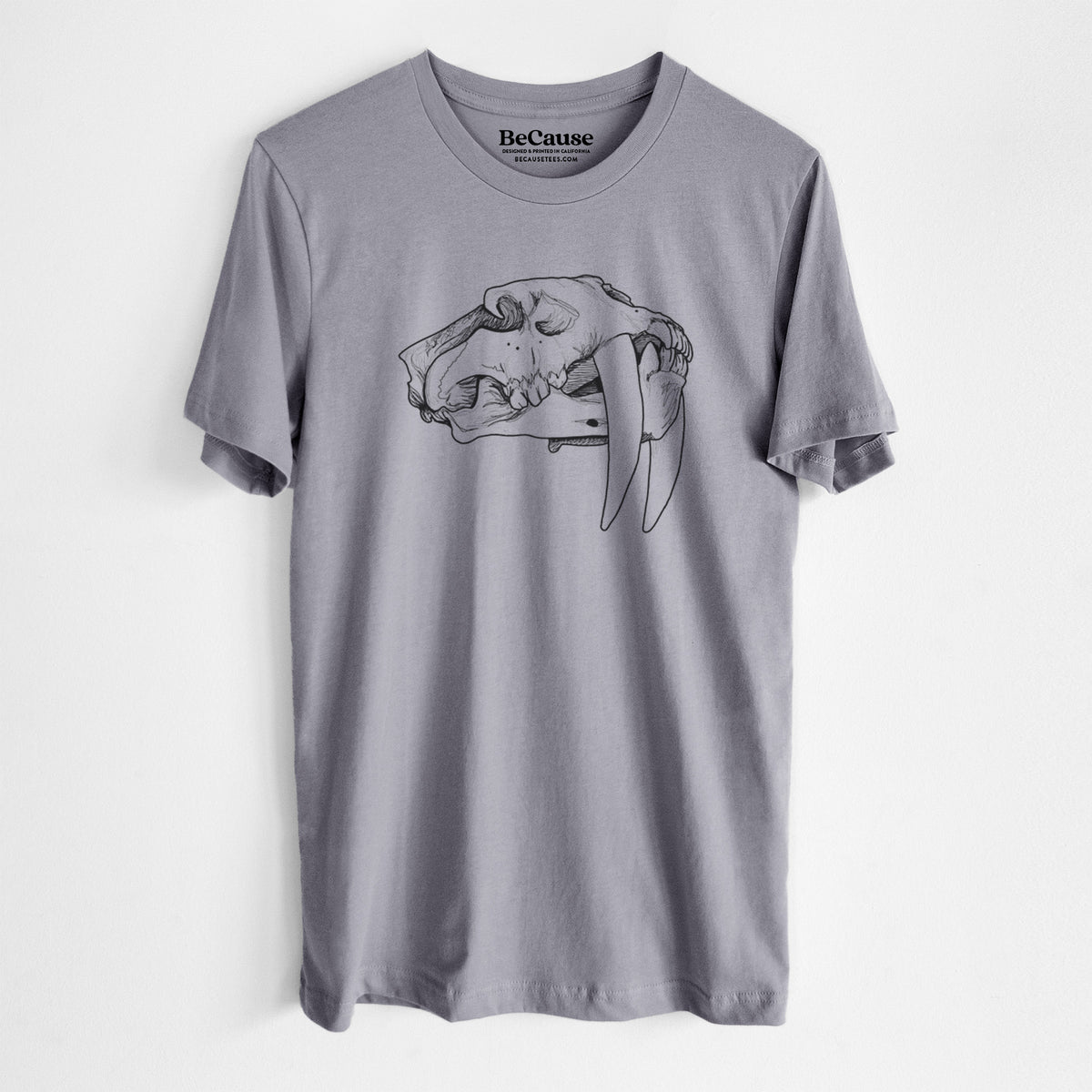 Storm grey lightweight cotton t-shirt laid flat, printed with a detailed black ink illustration of a saber-toothed tiger skull.
