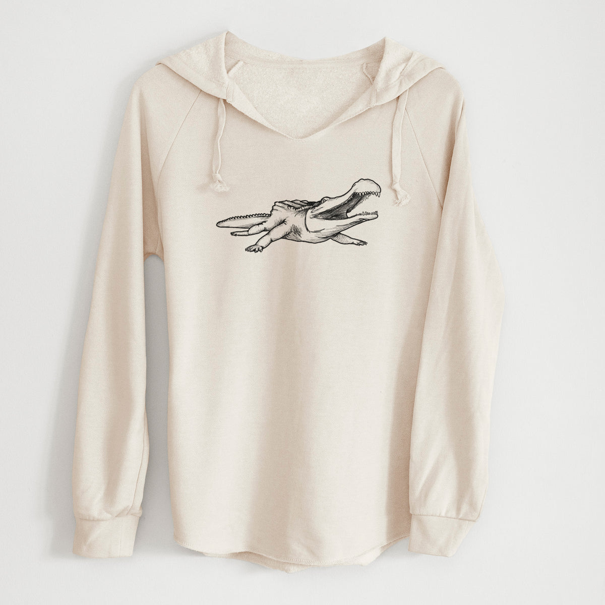 Bone cream women's Cali Wave hooded sweatshirt laid flat, printed with a black ink illustration of a Sarcosuchus, a giant prehistoric crocodile.