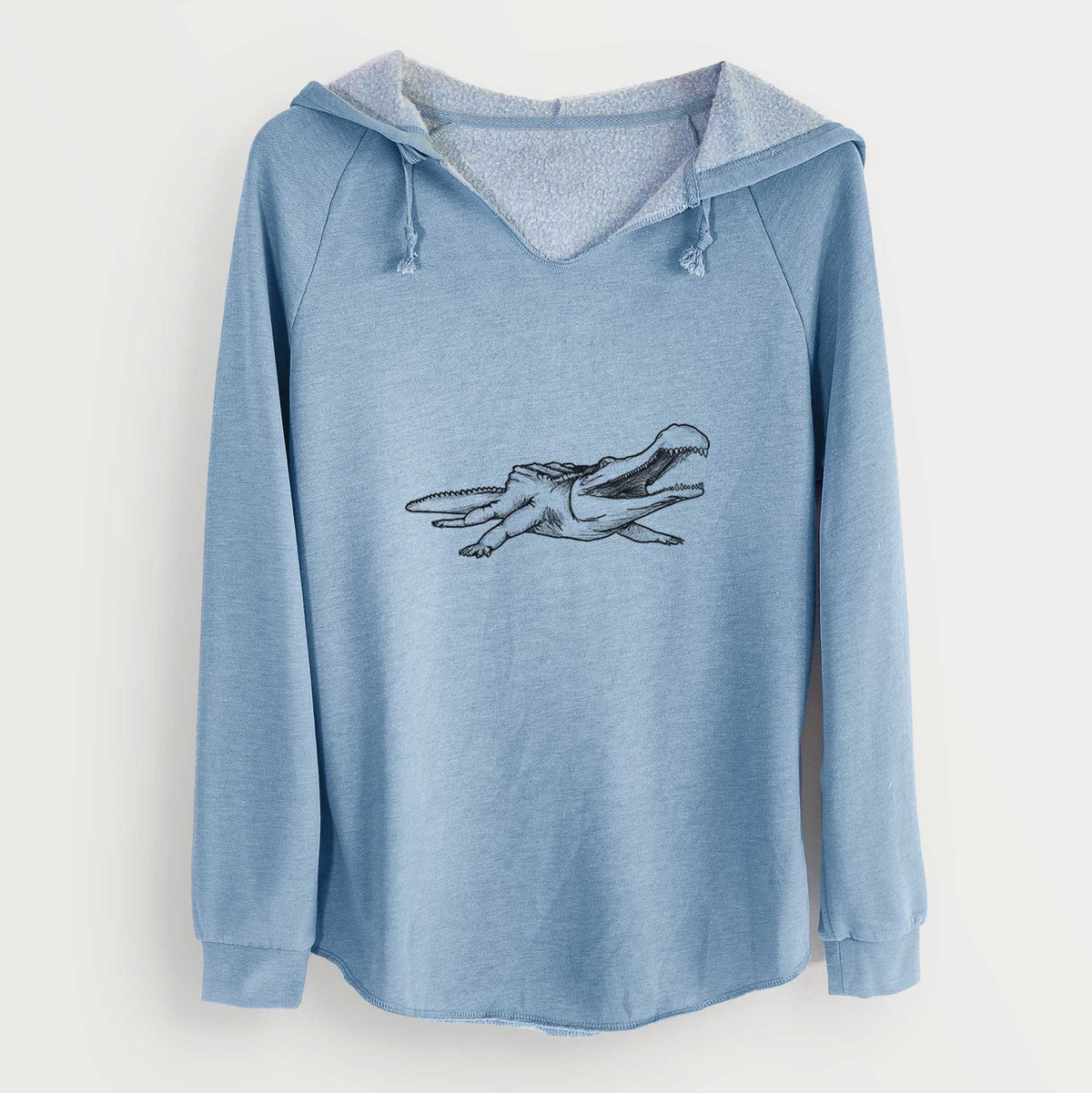 Misty blue women's Cali Wave hooded sweatshirt laid flat, printed with a black ink illustration of a Sarcosuchus, a giant prehistoric crocodile.