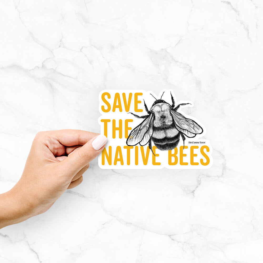 Hand holding a vinyl decal of yellow words reading Save the Native Bees beside a black ink bee.