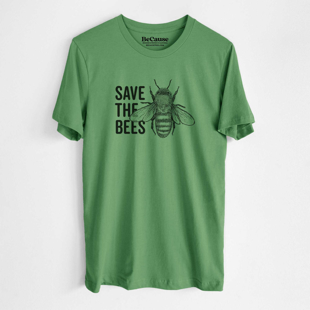 Leaf green lightweight cotton t-shirt laid flat, printed with bold black words reading Save the Bees beside a detailed honey bee illustration.