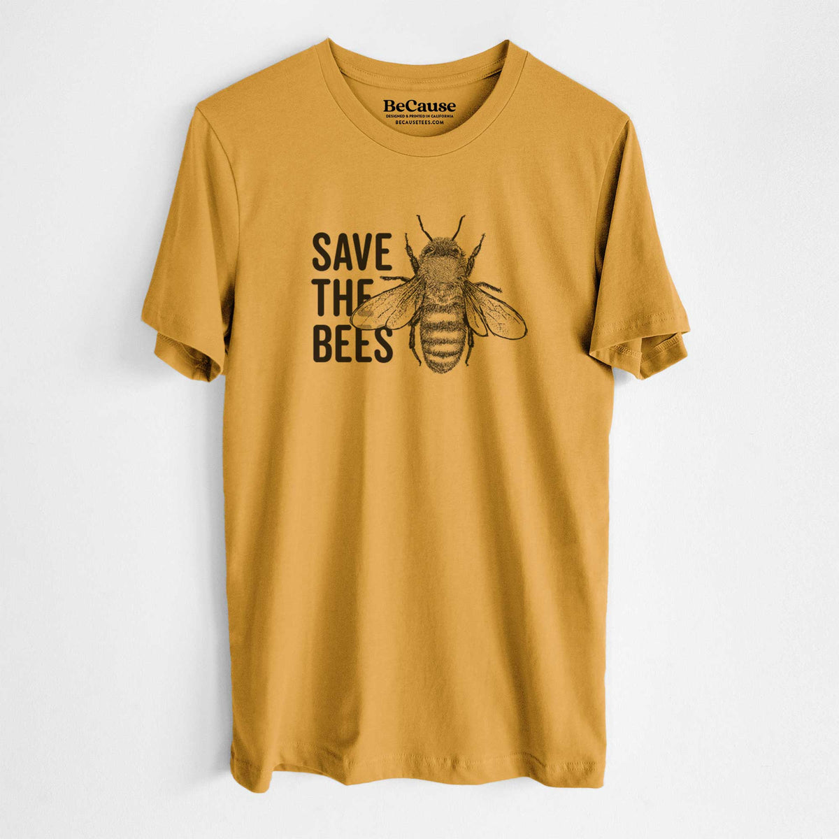 Mustard yellow lightweight cotton t-shirt laid flat, printed with bold black words reading Save the Bees beside a detailed honey bee illustration.