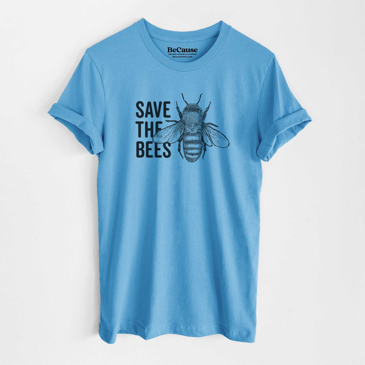 Ocean blue lightweight cotton t-shirt laid flat, printed with bold black words reading Save the Bees beside a detailed honey bee illustration.