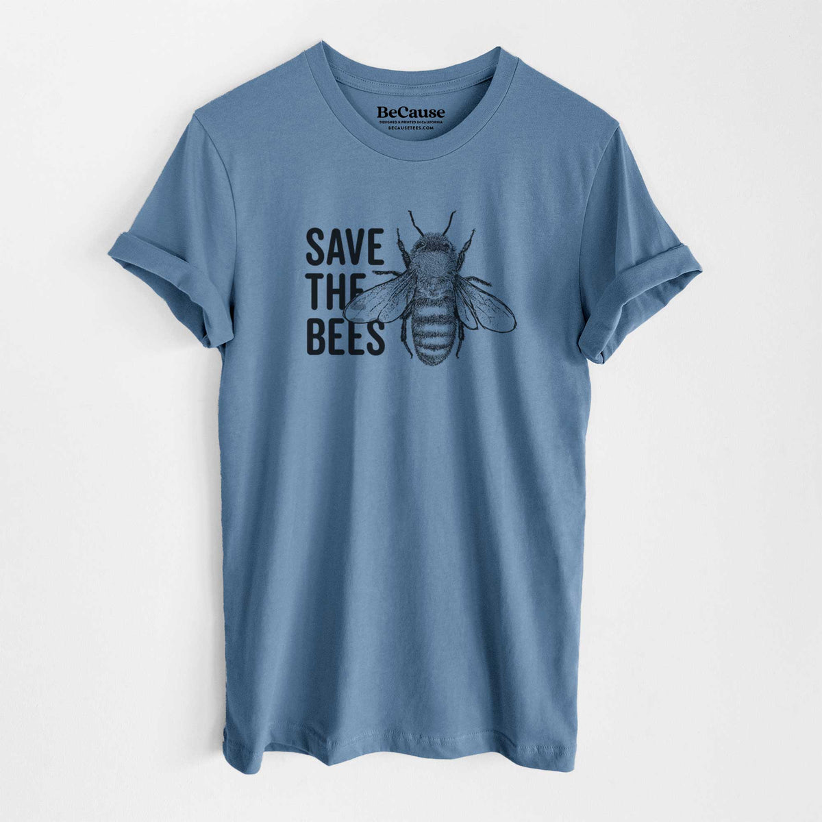 Steel blue lightweight cotton t-shirt laid flat, printed with bold black words reading Save the Bees beside a detailed honey bee illustration.