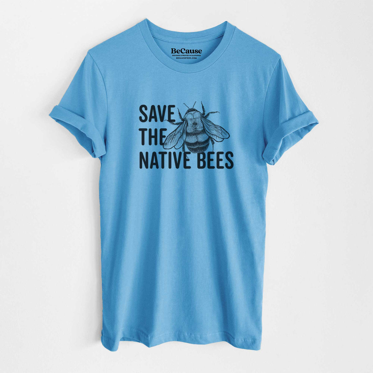 Ocean blue lightweight cotton t-shirt laid flat, printed with bold black words reading Save the Native Bees beside a detailed bee illustration.