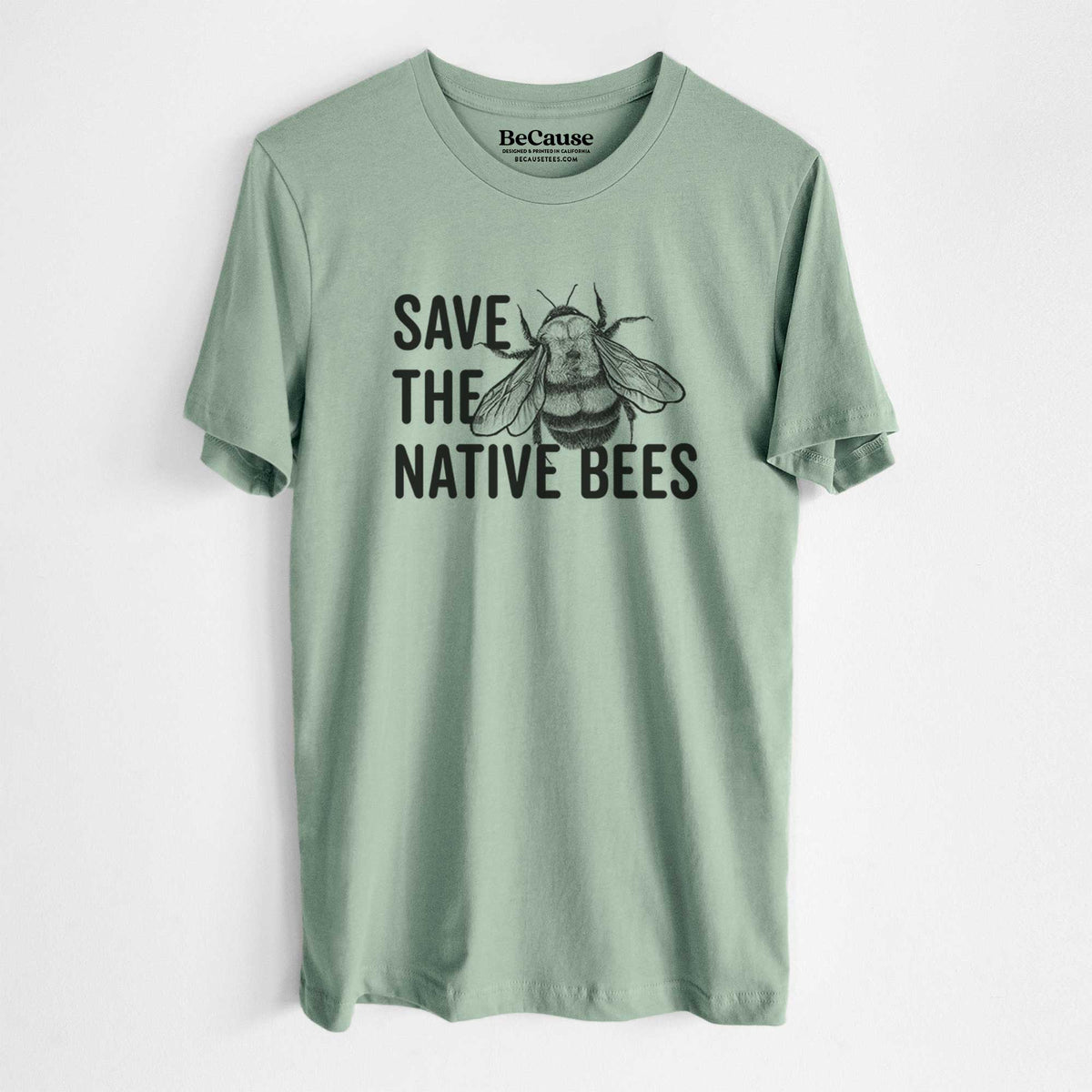 Sage green lightweight cotton t-shirt laid flat, printed with bold black words reading Save the Native Bees beside a detailed bee illustration.