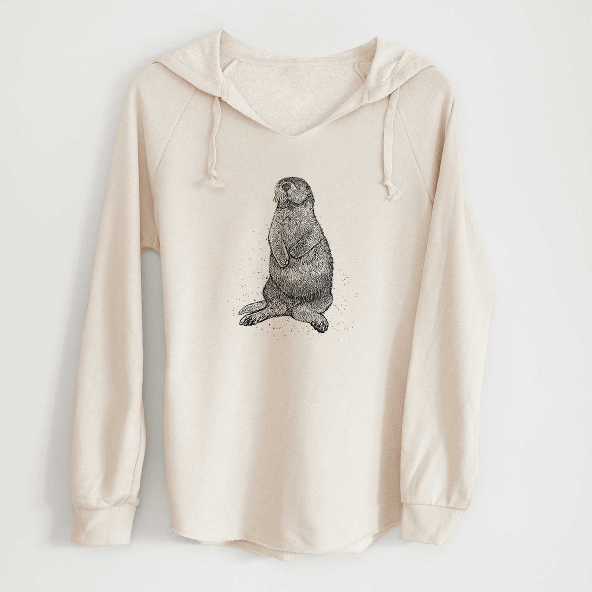 Bone cream women's Cali Wave hooded sweatshirt laid flat, printed with a detailed black ink illustration of a sea otter sitting upright.