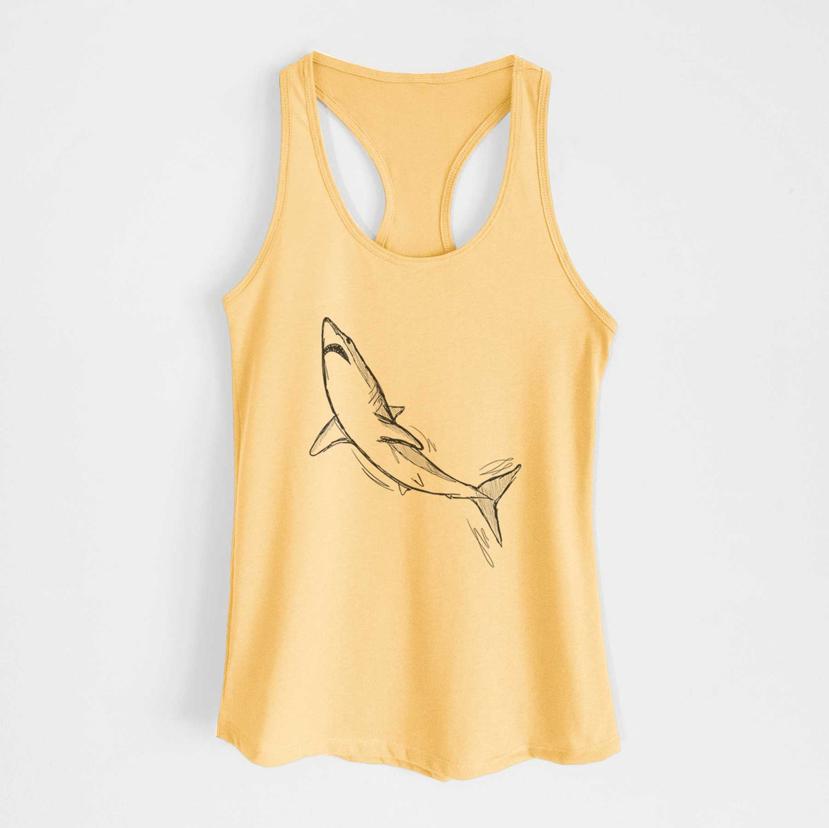 Banana cream women's racerback tank top laid flat, printed with a black ink illustration of a shortfin mako shark diving.