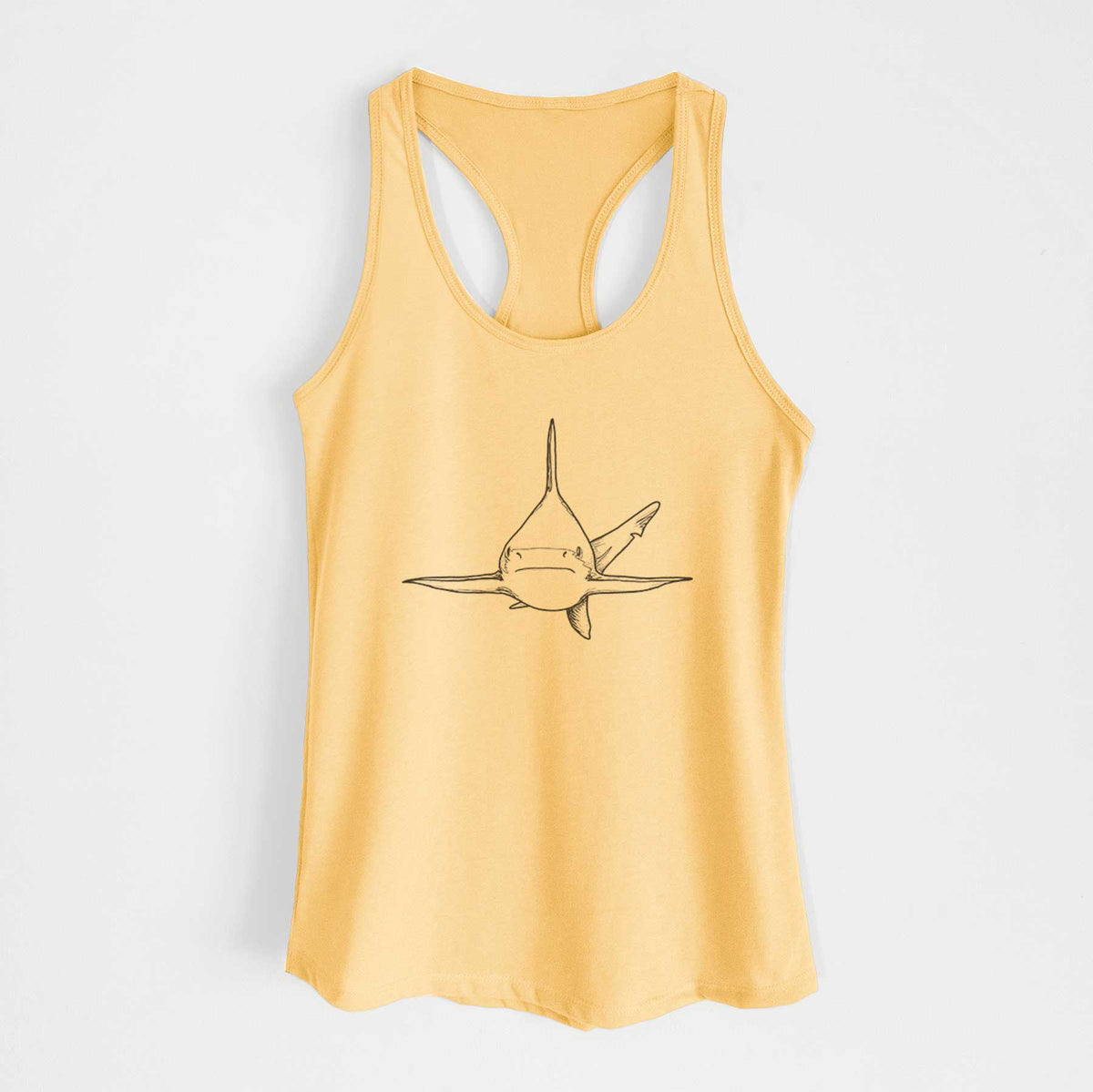 Banana cream women's racerback tank top laid flat, printed with a black ink illustration of a silvertip shark swimming head-on.