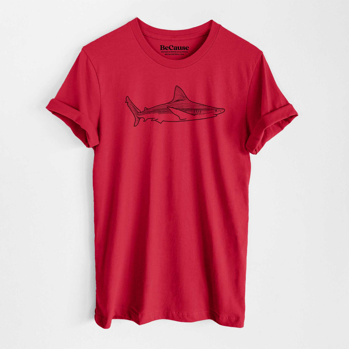 Ruby red lightweight cotton t-shirt laid flat, printed with a black ink illustration of a silvertip shark swimming in profile.