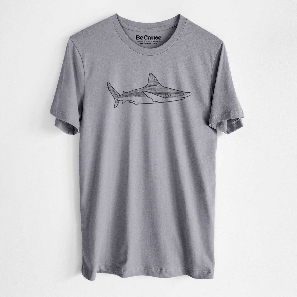 Storm grey lightweight cotton t-shirt laid flat, printed with a black ink illustration of a silvertip shark swimming in profile.